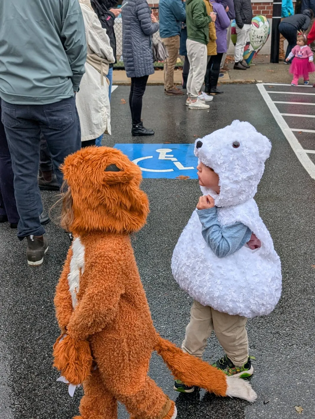 Two preschoolers dressed as a fox and a polar bear at Blossom Station's Halloween Parade in Acton, MA