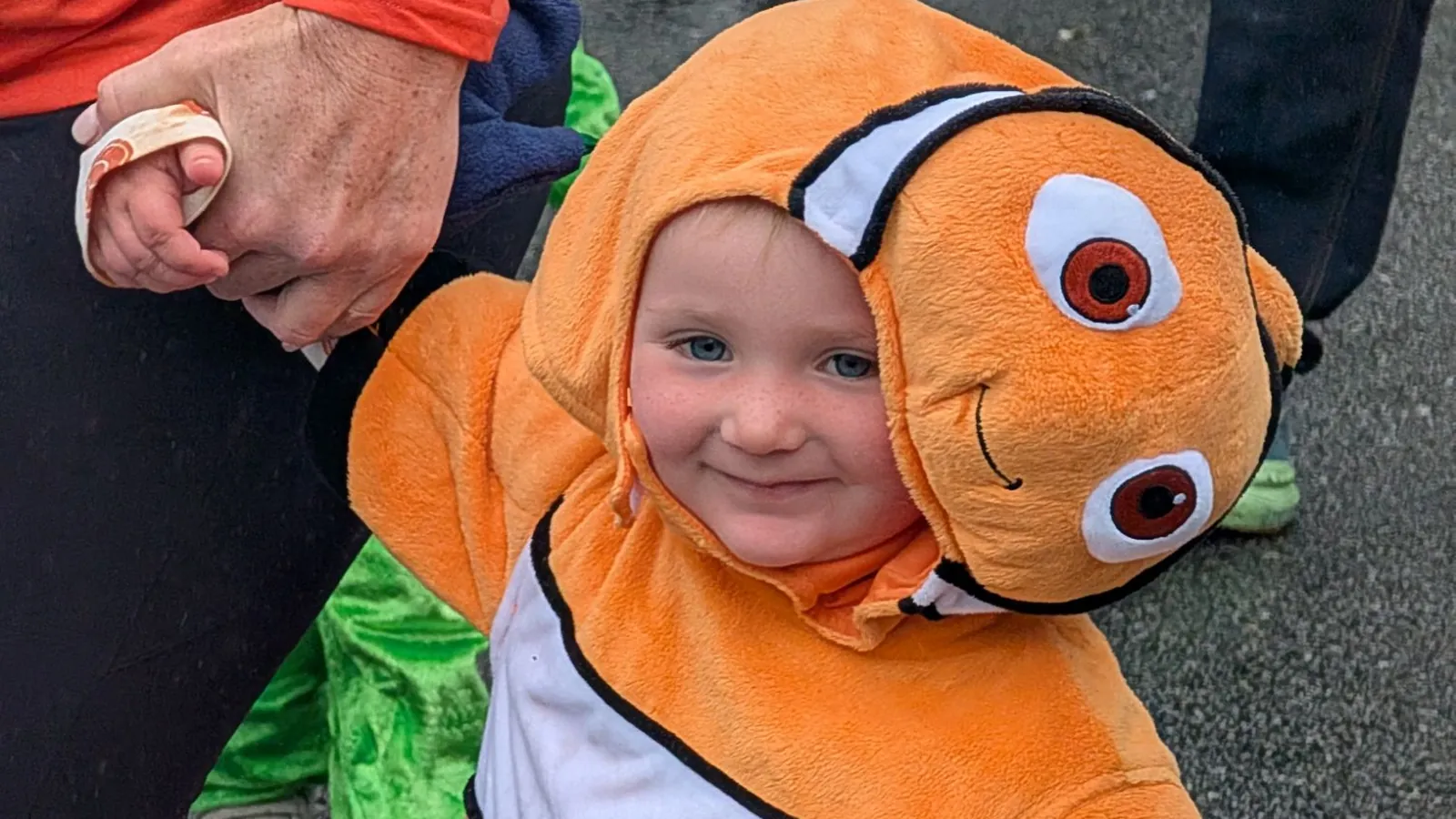 A smiling toddler in a clownfish costume at last year's Blossom Station Halloween Parade in Acton, MA