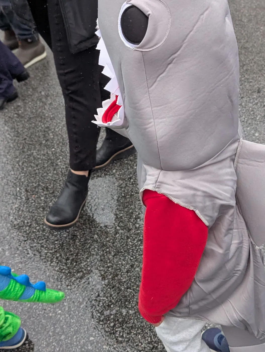 A child in a shark costume marching in the Blossom Station Halloween Parade