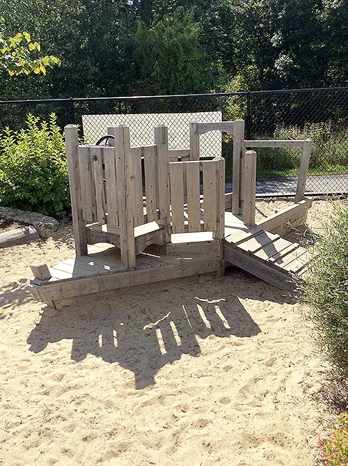 Children's wooden building and sand play structure at Blossom Station