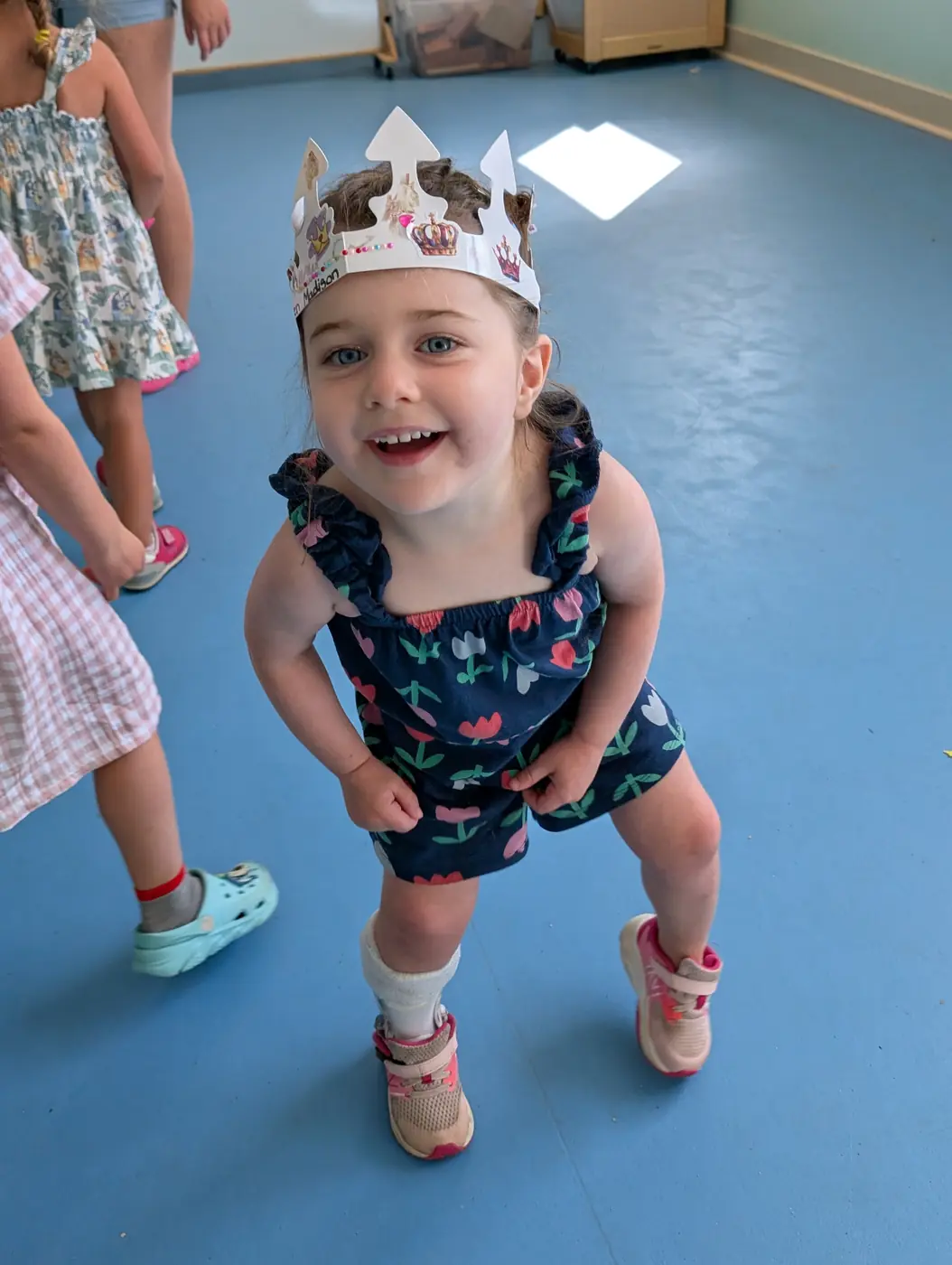 A happy preschooler wearing a handmade crown at Blossom Station's summer program